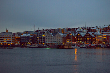 Typical Arctic coastal landscape in Tromsø, Norway, showing the icy waterfront and the city...