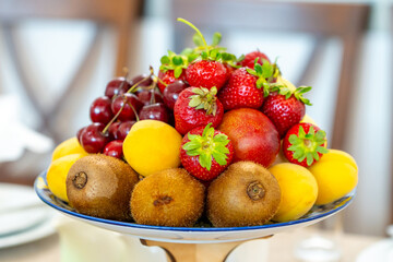 Raw fruits berries assortment platter on the plate, food