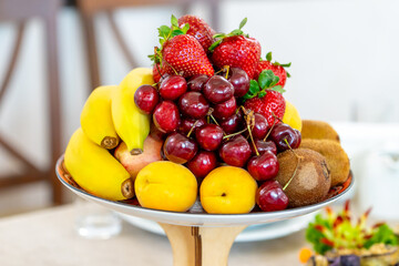 Raw fruits berries assortment platter on the plate, food