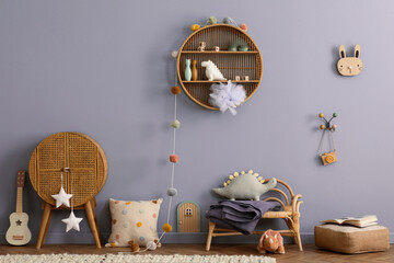 Creative composition of kids room interior with blue wall, rattan sideboard, armchair, pillows,...