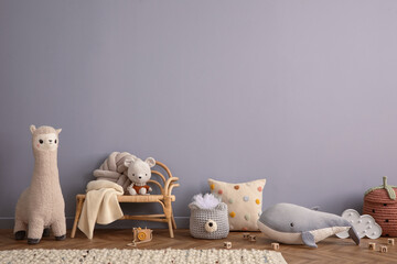 Warm and cozy living room interior with blue wall, rattan sideboard, stylish armchair, plush whale,...