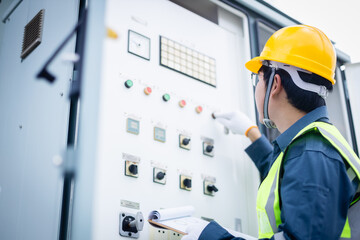 Engineer is working on high voltage power substation performing inspection and check of electrical...