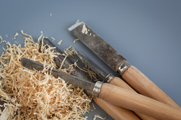 Shavings and wooden mallet on gray background
