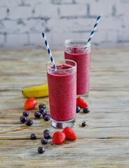 banana smoothie blended with fresh strawberries and blueberries