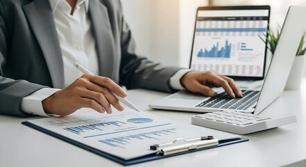 Businessman Using Tablet with Financial Reports