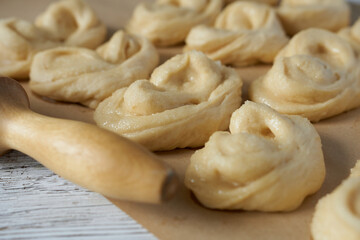 Raw buns on wooden background. Selective focus.