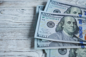 Dollars banknotes on old wooden background, close-up
