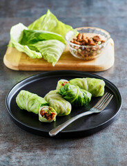 cabbage egg rolls stuffed with ground pork, garlic, and ginger