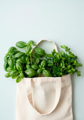 Reusable fabric tote with fresh basil leaves for eco lifestyle, food blog, packaging or organic brand design