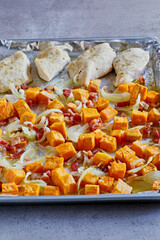 sheet pan chicken with sweet potato, onion, and bacon