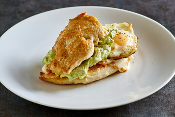 breakfast chicken breast stuffed with avocado, fried egg, and melted cheese