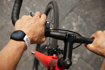 Cyclist hands riding with smartwatch. Fitness tracker and healthy progress apps. Close up.