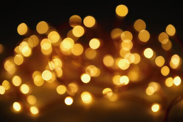 Warm and inviting string lights create a cozy atmosphere in a dimly lit space. Generative AI