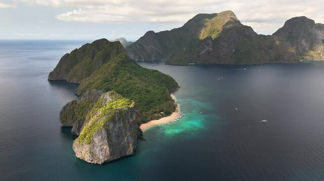 Drone footage of Duiklocatie and its lush headland in Helicopter Island, Philippines