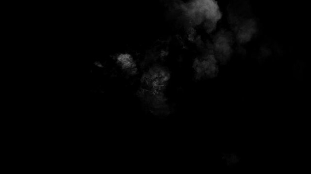 A small, turbulent cloud of white smoke materializes and drifts on a black background. Magical puff or mysterious vapor effect