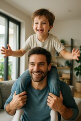 Handsome man carrying his son on his shoulders at home, smiling and having fun together.
