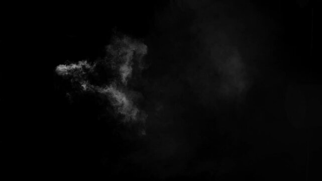 Isolated wisp of white smoke drifts from left to right on black background. Subtle vfx element for magic, vapor, or atmospheric details