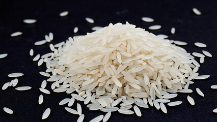 Pile of White Rice on a Black Background, a simple still life composition.