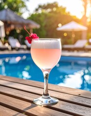 Frothy pink cocktail with a red garnish floats atop creamy foam, glowing in the sunlight by the poolside &mdash; refreshing and elegant summer indulgence.