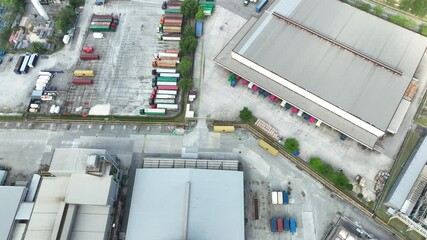Explore the busy logistics hub with an aerial view showcasing warehouses and parked trucks