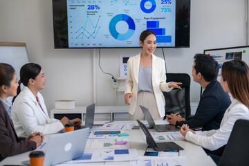 A woman is giving a presentation to a group of people