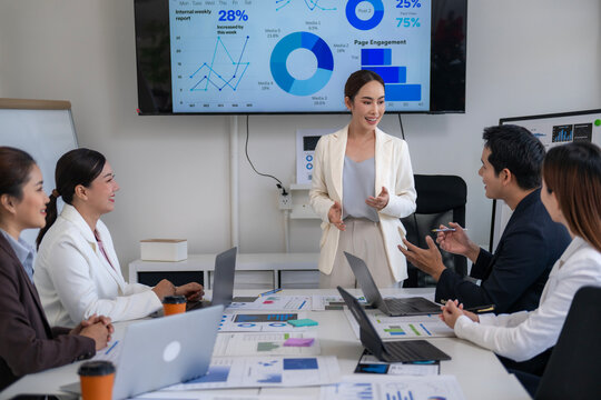 A woman is giving a presentation to a group of people