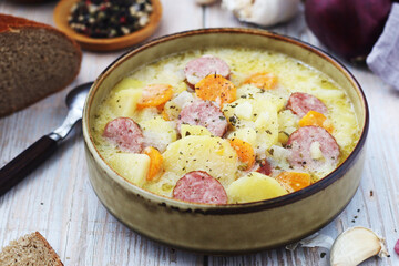 A bowl with traditional German potato soup with sausages