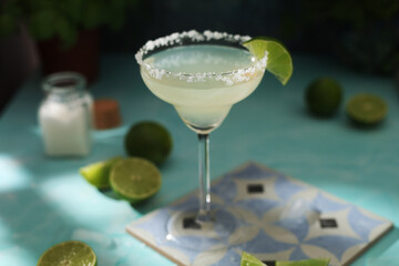 A glass with margarita cocktail with lime