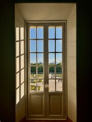 Elegant garden view from a palace window in Branicki Palace, Bialystok, Poland. Historical and peaceful scenery.