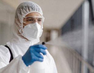 Fototapeta premium Healthcare Worker in Protective Suit Disinfecting Facility – Infection Control