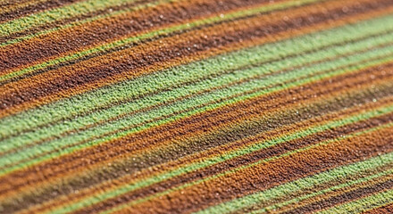 Detailed Macro View Of A Coarsely Woven Fabric With Diagonal Stripes In Warm Earthy Tones Of Green Brown And Orange For A Textured Abstract Background Or Natural Material Design Element