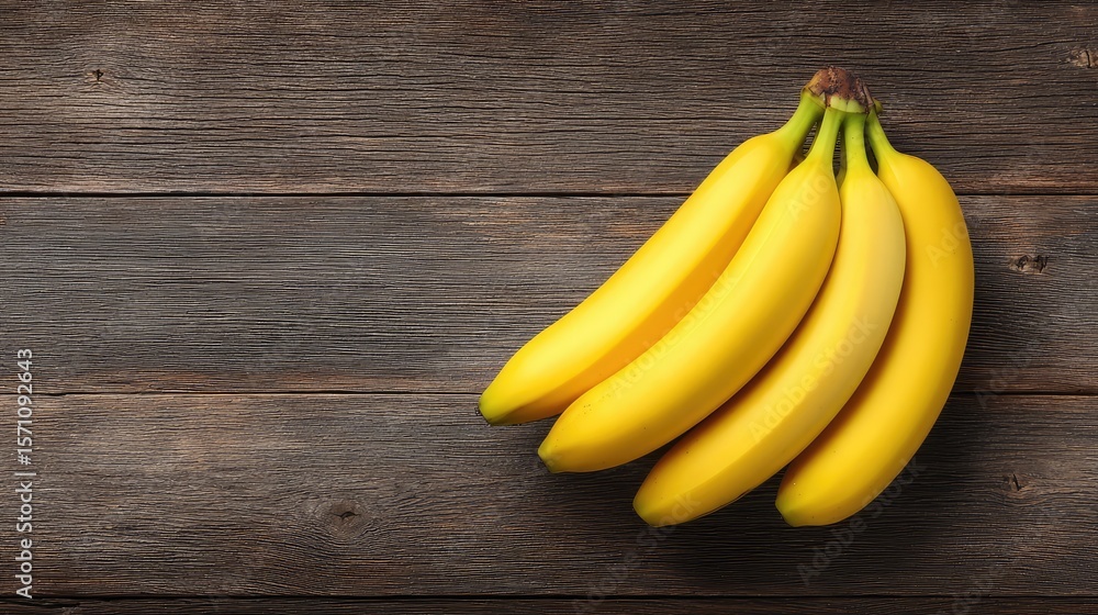 Aufkleber overhead view of a bunch of bananas on a wooden table with negative space for overlay or branding