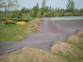Pump track close up. Pumptrack curves with lines. Asphalted bicycle race track, pump track...