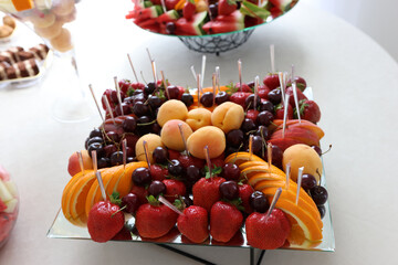 A variety of fruits on a sweet buffet table.