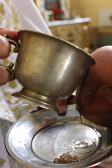 Baptism ceremony. The priest pours holy water on the head of a newborn.
