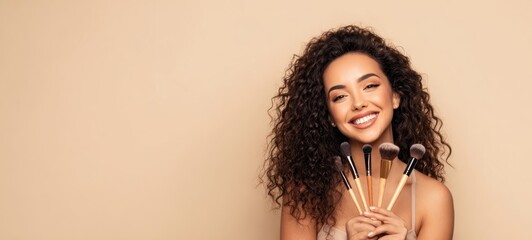The striking beauty holding makeup brushes and radiating joyful confidence