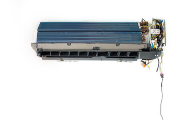 Air conditioner repair and maintenance. Indoor air conditioner unit with exposed coils and wiring,...