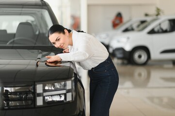 Woman hugging her new black car