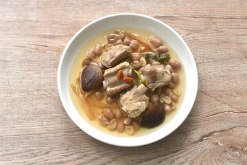 boiled chop pork bone with peanut and black mushroom soup on plate