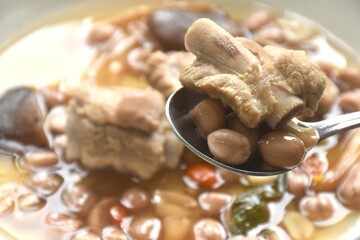 boiled chop pork bone with peanut and black mushroom soup on plate