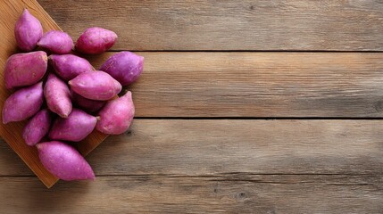 Naklejka premium Fresh Purple Sweet Potatoes on Wooden Table Background