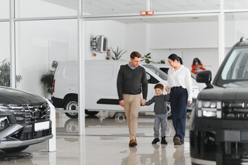 family choosing a car in dealership, they want the most comfortable and safe car