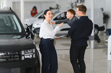 Father and son choosing a new car to buy at the car showroom