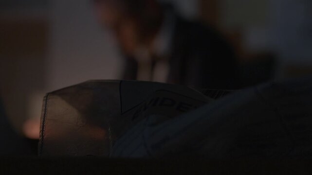 Out of Focus shot of FBI agent looking at documents