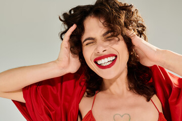Joyful summer vibes exuding confidence and style in a vibrant red outfit