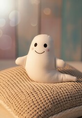 Cute smiling ghost plush on knit blanket with soft bokeh background for Halloween decor