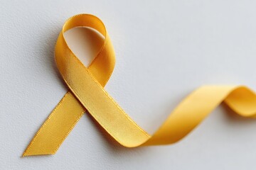 Symbolic yellow ribbon elegantly twisted on soft background, rep