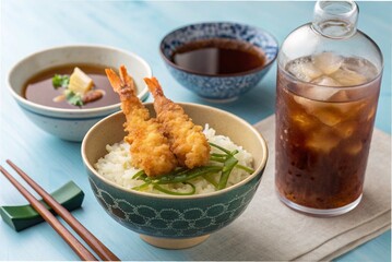 Japanese shrimp tempura rice bowl, miso soup and iced black tea, on a blue table