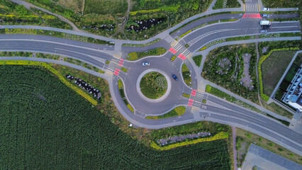 Aerial view of a modern green roundabout with bike lanes and pedestrian crossings