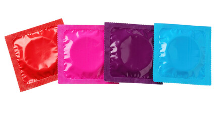 Four colorful condoms in individual packages isolated on transparent background